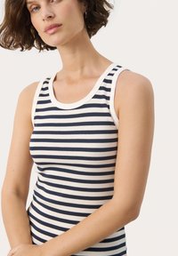 Navy and white striped tank top with a ribbed texture, featuring a round neckline and wide armholes, showcasing a fitted silhouette.