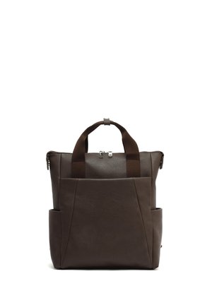 Brown leather bag with dual top handles, zip closure, and exterior side pockets, featuring a smooth texture and minimalist design.