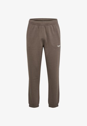 Bruna mjukisbyxor av mjukt tyg med elastisk midja och muddar, med en liten vit logotyp på nedre vänstra benet.