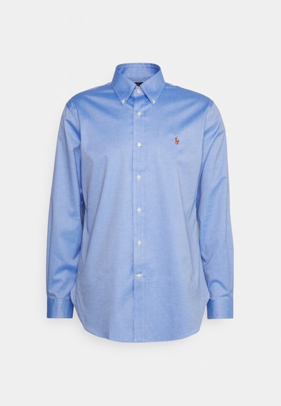 Lichtblauw overhemd met knoopsluiting, kraag, lange mouwen en een klein logo op de linkerborst. Gemaakt van gladde katoenen stof.
