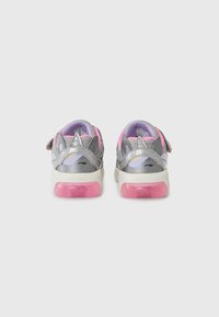 Silver and pink children's sneakers with a textured upper, featuring a unicorn design and a light-up pink sole. Velcro strap for closure.