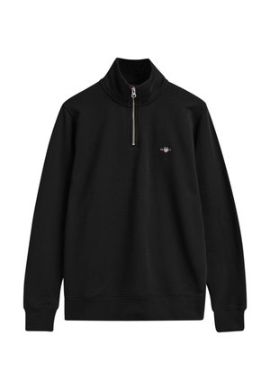 Sudadera negra con cremallera y cuello alto, fabricada en un tejido suave. Presenta un pequeño logotipo en el pecho y puños y dobladillo de canalé.