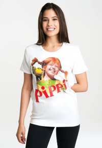 White cotton t-shirt featuring a colorful graphic of a girl with orange hair and pigtails, holding a frog, with "Pippi" text below.