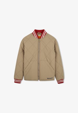 Veste matelassée beige avec fermeture éclair devant, col et poignets rayés rouge et blanc, deux poches avant, logo Timberland en bas à gauche.