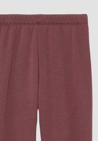 Bordeaux legging gemaakt van een zachte, gestructureerde stof. Heeft een elastische tailleband met een gladde afwerking en geen zichtbare naden.
