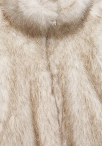 Faux fur coat in cream and light brown. Features a soft texture, fur collar, and hidden closure. Subtle color variations add depth.