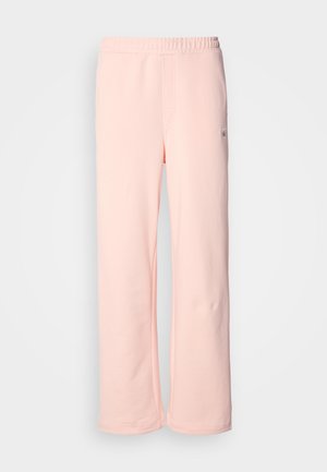 Roze pamučne trenirke s širokim nogavicama, elastičnim pojasom i minimalnim detaljima šivanja. Ima malu oznaku s logotipom sa strane.
