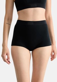 Svarta högmidjade trosor med en slät yta, elastiskt midjeband och minimal branding, designade för komfort och stöd.