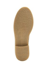 Suela de zapato de goma crepe de color marrón claro, con textura suave y sección de tacón definida.