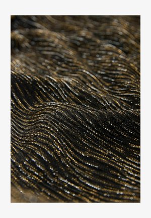Czarna i złota tkana tkanina z metalicznymi włóknami ułożonymi w faliste wzory, odbijająca światło, co tworzy efekt migotania.