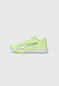 Bright yellow athletic shoe featuring a mesh upper, a cushioned sole, and a curved design with a contrasting dark green accent line.