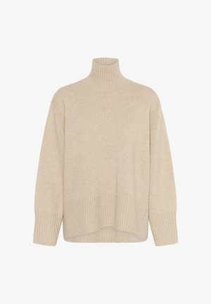 Beige polotröja tillverkad av mjukt stickat material. Har ribbade kanter och mudd, med en avslappnad passform och långa ärmar.
