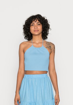Top cropped canelado azul claro com decote halter e um design justo, combinado com uma saia fluida e em camadas correspondente.
