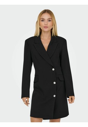 Zwarte op maat gemaakte blazer jurk met lange mouwen, geknipte revers en twee voorzakken. Beschikt over zilveren knoopdetails en een gladde textuur.