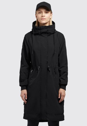 Svart parkas med hög krage, dragsko i midjan och sidofickor med dragkedja. Tillverkad av lätt material med en mjuk yta. Långa ärmar.