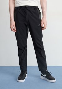 Nike Sportswear - TECH WOVEN PANT - Tracksuit bottoms - black Thumbnail Image 1