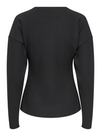 Haut noir à manches longues et coupe ajustée avec épaules légèrement structurées et ourlet arrondi, présenté de dos sur un fond blanc.