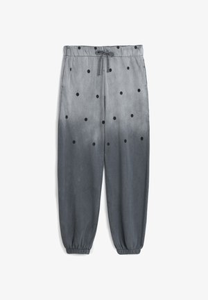 Gray sweatpants with black polka dots, elastic waistband, and cuffs. Fabric has a smooth texture with an ombre gradient effect.