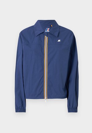 Navy blue jacket with a pointed collar, front zip closure featuring a multicolored stripe, elasticized cuffs, and a logo on the chest.