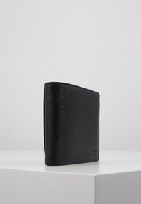 Black leather wallet with a textured finish, featuring blue stitching accents along the edges, folding design, and compact shape.
