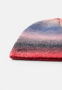 Gorro de punto con un patrón degradado en tonos de gris, azul, rosa y rojo, hecho de hilo suave y texturizado.