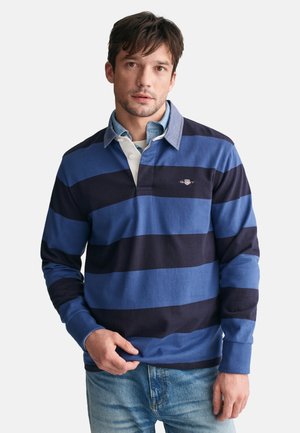 Langarm-Poloshirt in Blau und dunkelblauen Streifen, aus Baumwollmaterial, mit einem kragenförmigen Ausschnitt und einer hellblauen Unterschicht sowie einem Logo.