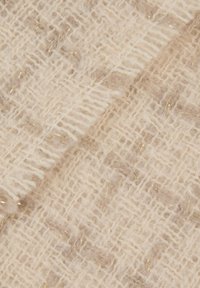 Tessuto intrecciato beige chiaro con un motivo testurizzato, caratterizzato da sottili filamenti dorati intrecciati, creando un aspetto morbido e accogliente.