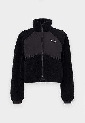 Black zip-up jacket with fleece and smooth fabric panels, high collar, and ribbed cuffs. Features logo on the chest and front zip pockets.