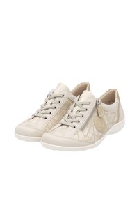 Baskets décontractées beiges avec lacets à l'avant, fermeture éclair latérale, motif géométrique et écusson logo rond sur semelles blanches.