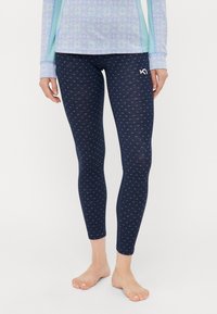 Marine leggings laget av elastisk stoff, med et subtilt trykk av små former og et logoakcent på venstre hofte.