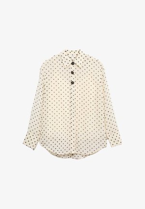 Krämfärgad skjorta med knappar och svarta prickar, långa ärmar, klassisk krage och dekorrerade knappar framtill.