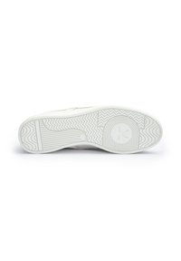 Biała podeszwa trampka z teksturowanym wzorem z gumy, zygzakowatymi wzorami i okrągłymi zdobieniami. Logo umieszczone na obszarze pięty.