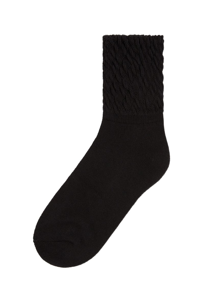 Svart strumpa med en texturerad kabelstickad design vid skaftet, gjord av mjukt material, med en slät kropp och rund tå.