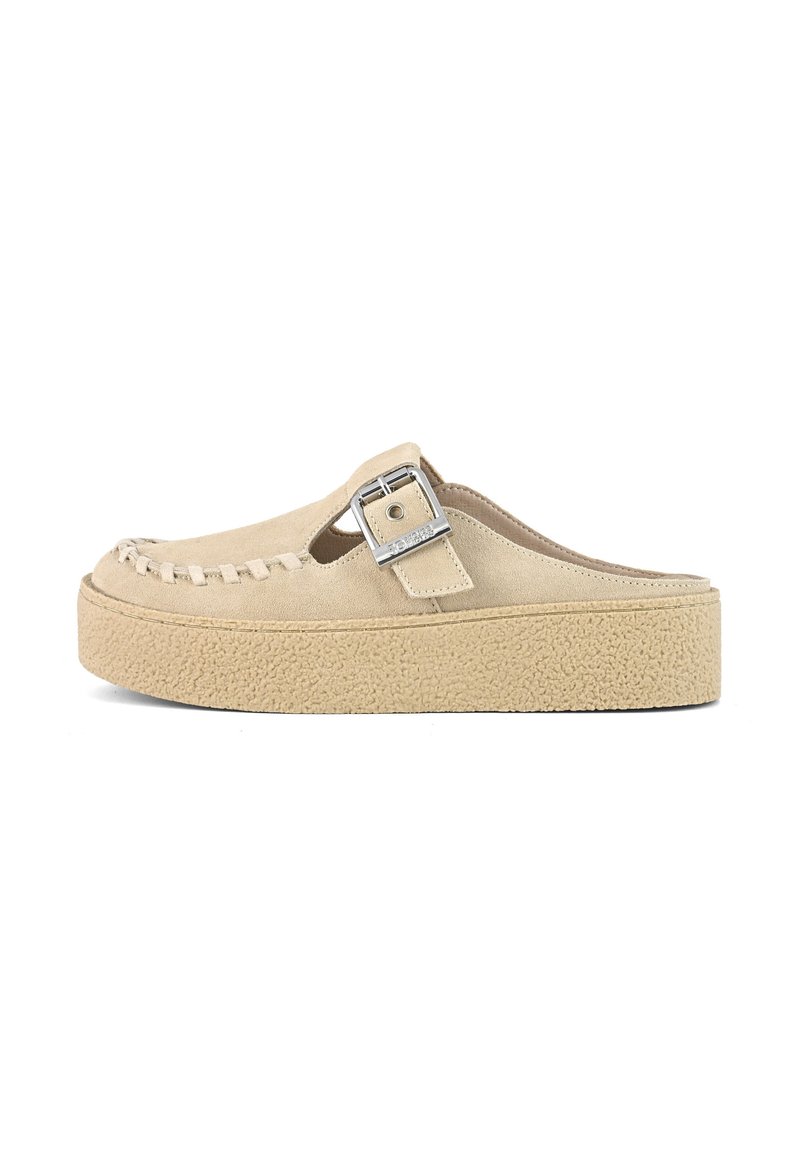 Beige suede slip-on shoe with a woven design on the toe, raised platform sole, and a silver buckle accent on the upper.