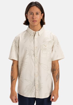 Camicia a maniche corte in crema con un motivo a contorni botanici, chiusura a bottoni e taschino sul petto. Realizzata in tessuto leggero.