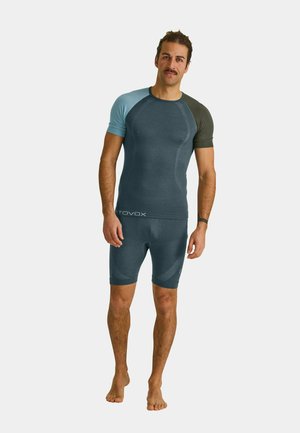 Men's activewear set featuring a short-sleeve dark blue top with light blue and dark green accents, paired with matching fitted shorts. Soft texture.