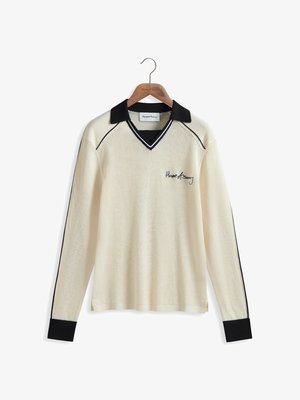 Cream-colored mesh long-sleeve shirt with a black collar and cuffs, featuring a v-neck and black accent lines. Embroidered logo on the front.