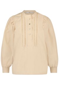 Blouse beige à manches longues bouffantes, boutonnée à l'avant, avec des détails de couture décorative. Confectionnée en tissu léger.