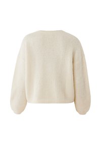 Krämfärgad oversized tröja med en texturerad, stickad design. Har långa, puffiga ärmar och en rundad halsringning.