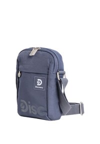 Kompakte dunkelblaue Umhängetasche mit verstellbarem Riemen, vorderer Reißverschlusstasche und Discovery-Markenlogo auf der Vorderseite.