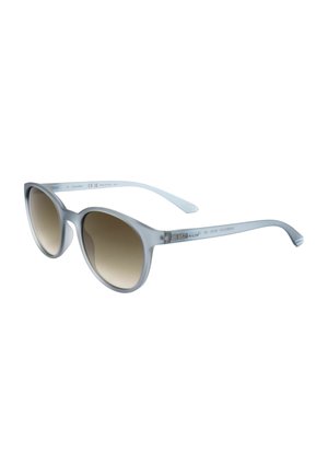 Occhiali da sole cat-eye traslucidi grigio chiaro con lenti marroni sfumate e sottili aste con logo Calvin Klein.
