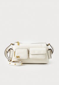 White leather crossbody bag with two front pockets, gold hardware, adjustable strap, and embossed "MK" logo on the side.