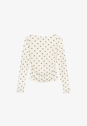 Pitkähihaiset paita kermavärisestä kankaasta, jossa on kerätty sivu ja pieniä ruskeita pilkkuja koko pinnalla. Sujuva ja kevyt rakenne.