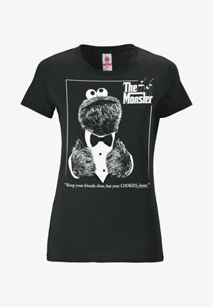 Black cotton t-shirt featuring a printed graphic of a monster in a tuxedo, with the text: "The Monster" and a quote about cookies.