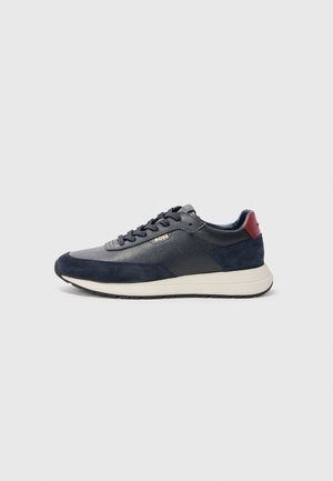 Navy blue sneakers with a combination of leather and suede materials, featuring a textured finish, round toe, and contrasting maroon heel accent.