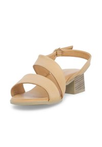 Sandali con tacco in pelle beige, dotati di due fasce incrociate e di un cinturino alla caviglia. Il tacco a blocco presenta una finitura testurizzata. Design open-toe.