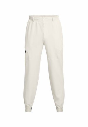 Lys beige joggingbukser med elastisk talje, sidelommer og ribbede manchetter; har en sort logoaccent på venstre hoft.