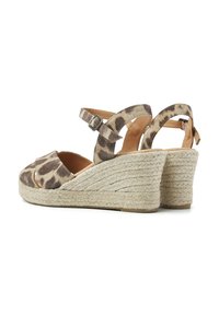 Leopard print wedge sandals with a fabric upper, adjustable ankle strap, and woven jute heel detail. Open toe design enhances breathability.