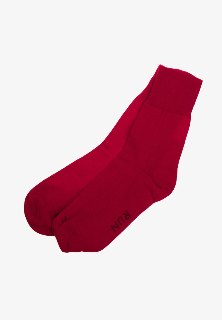 Red ankle socks made of smooth fabric, featuring a ribbed cuff and printed logo on the side. Simple, solid color with no patterns.