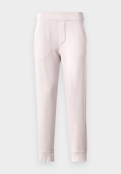 Light pink sweatpants made of soft material, featuring an elastic waistband, side pockets, and ribbed cuffs at the ankle.